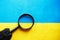 UKRAINE flag looking through a magnifying glass. The study of the history and culture of the people of the country of Ukraine. The