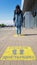 Ukraine, Kiev - April 23, 2020. Yellow pavement with warning. Keep your distance on the sidewalk. The text is in Ukrainian.