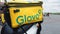 Ukraine, Kiev - August 29, 2020. Parked moped with yellow bag with Glovo logo near McDonald`s close-up. Courier service that