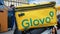 Ukraine, Kiev - August 29, 2020. Parked moped with yellow bag with Glovo logo near McDonald`s close-up. Courier service that