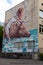 Ukraine, Kiev - May 18, 2020: Graphite at the end of the building A man and an elk cross the river. Wall painting. Street painting
