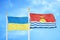 Ukraine and Kiribati two flags on flagpoles and blue sky
