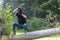 Ukraine, Kyiv, August 25, 2018: A young guy makes a landscape photographing camera Kenon. Removes a small swamp in the forest
