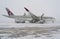 Ukraine, Kyiv - February 12, 2021: De-icing the aircraft before the flight. The deicing machine sprinkles the wing of a passenger