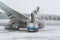 Ukraine, Kyiv - February 12, 2021: De-icing the aircraft before the flight. The deicing machine sprinkles the wing of a passenger