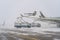 Ukraine, Kyiv - February 12, 2021: De-icing the aircraft before the flight. The deicing machine sprinkles the wing of a passenger