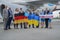 Ukraine, Kyiv - September 1, 2021: Stewardesses and pilots. Stewardess holding the flag of Germany. The pilot smiles