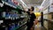 Ukraine, Mariupol, July 18, 2021. Front view of young male customer in face mask walks along aisle in hardware shop and