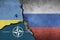 Ukraine, russia and nato flags painted on concrete wall. To simulate the Conflict between russia and ukraine in europe.