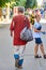 Ukraine, Shostka - August 24, 2019: A homeless man in ragged dirty clothes is walking along a city street