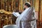 Ukraine,Shostka, Vladimirskaya Church -March 3, 2019: The priest performs the rite of the sacrament of baptism