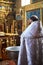 Ukraine,Shostka, Vladimirskaya Church -March 3, 2019: The priest performs the rite of the sacrament of baptism