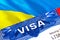Ukraine Visa in passport. USA immigration Visa for Ukraine citizens focusing on word VISA. Travel Ukraine visa in national