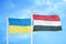 Ukraine and Yemen two flags on flagpoles and blue sky