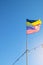 Ukrainian and American flag on a blue sky background. Friendship of peoples and diplomatic mission. Yellow-blue and stars-striped