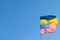 Ukrainian and American flag on a blue sky background. Friendship of peoples and diplomatic mission. Yellow-blue and stars-striped