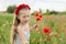 Ukrainian Beautiful girl in field of poppies and wheat. outdoor portrait in poppies