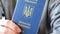 Ukrainian biometric passport in the hand of its owner.