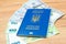 Ukrainian biometric passport id to travel the Europe with dollars and euros money on the table. Inscription in Ukrainian