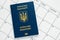 Ukrainian biometric passport on white page of calendar. Planning vacation concept. International blue passport