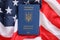 Ukrainian biometrical passport on folded waving flag of United States of America