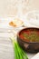 Ukrainian borsch with green onions, bread and garlic