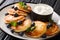 Ukrainian breakfast of cottage cheese pancakes with blueberries, mint and sour cream close-up in a plate. horizontal