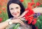 Ukrainian brunette woman with a bouquet of poppies