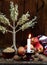 Ukrainian Christmas concept for greeting card. Composition of xmas symbol didukh, burning candle, apples, walnuts, wheat on wooden