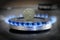 Ukrainian coin hryvnia on gas hob with burning natural gas