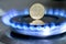 Ukrainian coin hryvnia on gas hob with burning natural gas