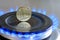Ukrainian coin hryvnia on gas hob with burning natural gas