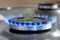 Ukrainian coin hryvnia on gas hob with burning natural gas