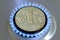 Ukrainian coin one hryvnia on a burning natural gas hob