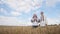 A Ukrainian family in embroidered dresses sings a song in the middle of a wheat field.