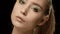 Ukrainian fashion model face closeup isolated on black background. Beautiful model girl makeup. Gorgeous brunette