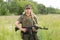 Ukrainian female military servicewoman with a machine gun in her hands in the field