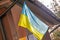 Ukrainian flag displayed on an architectural building, the context of war in Ukraine,