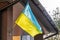 Ukrainian flag displayed on an architectural building, the context of war in Ukraine,