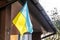 Ukrainian flag displayed on an architectural building, the context of war in Ukraine,