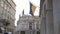 The Ukrainian flag is displayed on the facade of a city building in the city center, the old architecture of Europe.