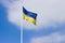 Ukrainian flag flying in the wind against of a sky