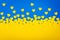 Ukrainian flag made of blue background and yellow hearts. Papercut concept of ukrainian motive