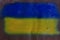 Ukrainian flag painted on a sheet of metal with traces of bullets