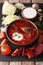 Ukrainian food: red soup borsch with ingredients on slate board