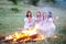 Ukrainian girl in shirts sitting around the campfire