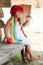 Ukrainian girl in a wreath of red flowers on a bench with an apple in his hand