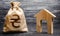 Ukrainian hryvnia UAH symbol money bag and house. Real estate purchase and investment. Affordable loan, mortgage. Taxes, rental