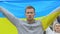 Ukrainian male activist raising flag, peaceful reform rally, patriotic nation