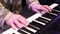 A Ukrainian military man plays a keyboard instrument. Hands close up